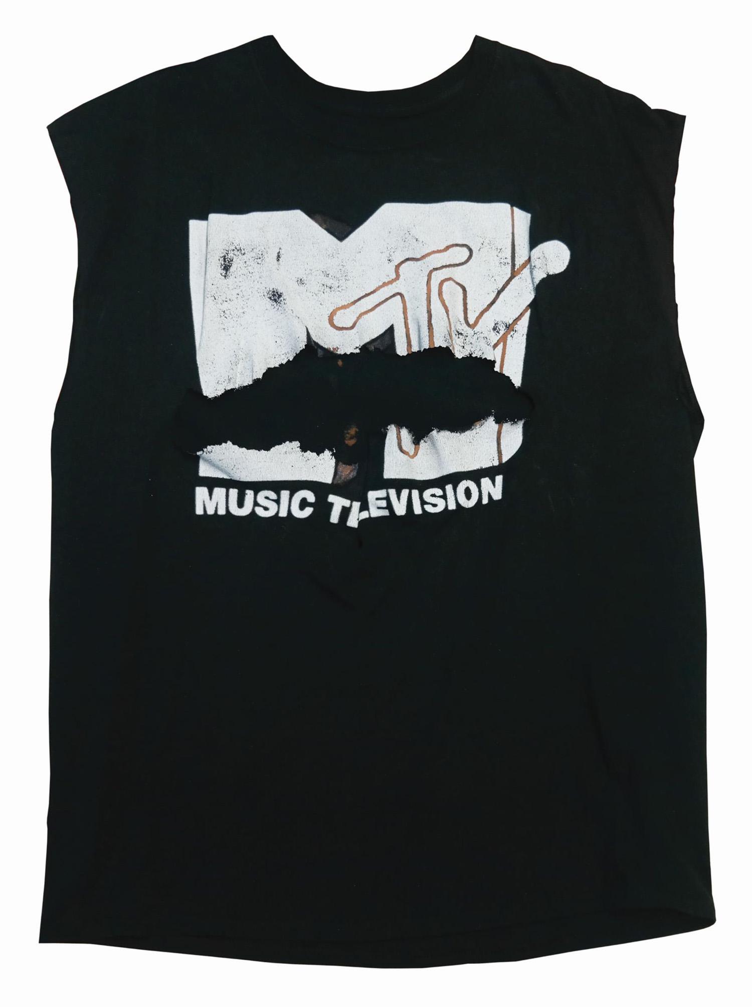 Jesse Ventura Predator Prop Shirt.: (20th Century Fox, 1987) A shirt worn by Jesse Venture as Blain in Predator. The MTV t-shirt is intentionally ripped in the center to be used in the scene where the Predator rips Blain's chest open. T
