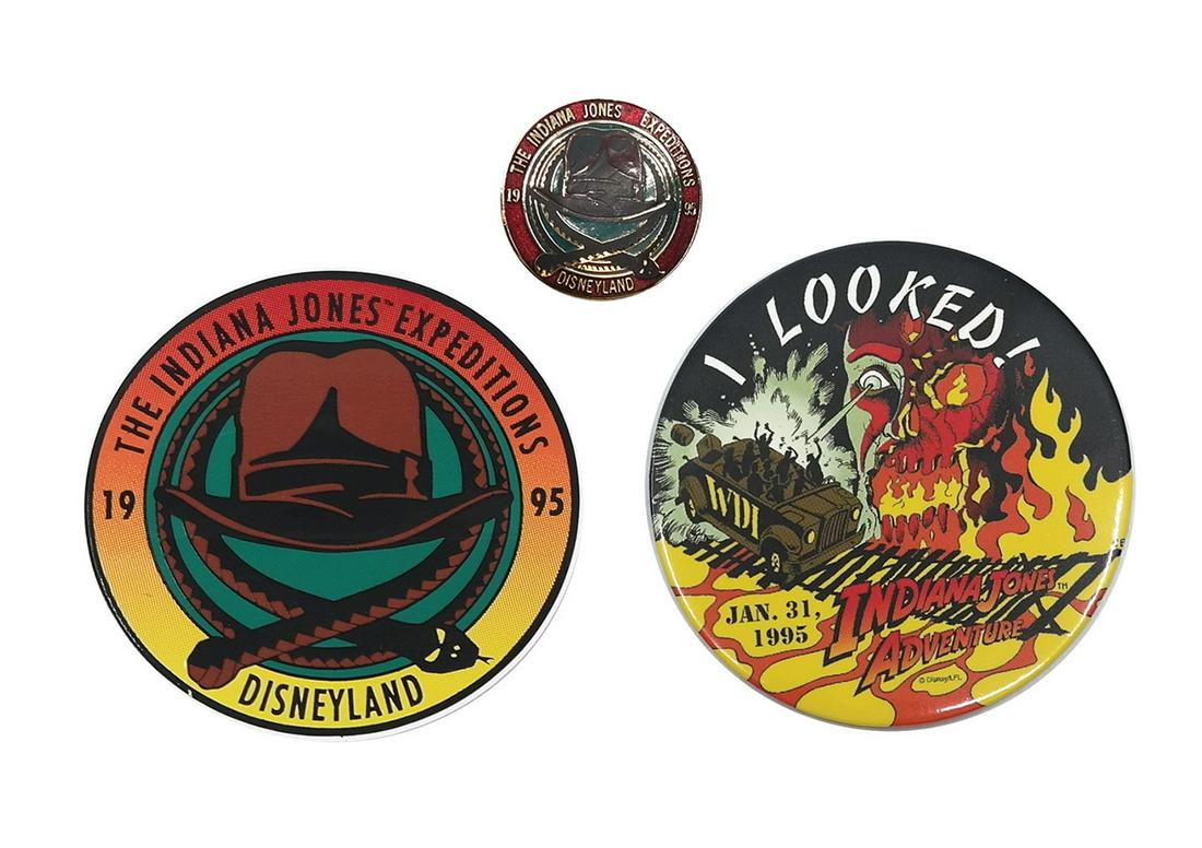 Set of (3) Indiana Jones Adventure Project Team Items.: (Disneyland, 1995) A rare collection of items given to members of the project team for Indiana Jones Adventure. The collection includes a button, pin, and sticker. The button is very rare and is dated