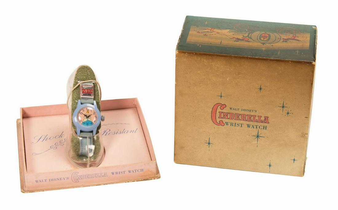 Cinderella "Glass Slipper" Boxed Watch.: (Disney, 1950) A boxed Cinderella watch within a "glass slipper" display. The slipper measures approximately 3" tall at the highest point and 3.5" long. The watch is in good condition with minimal wea