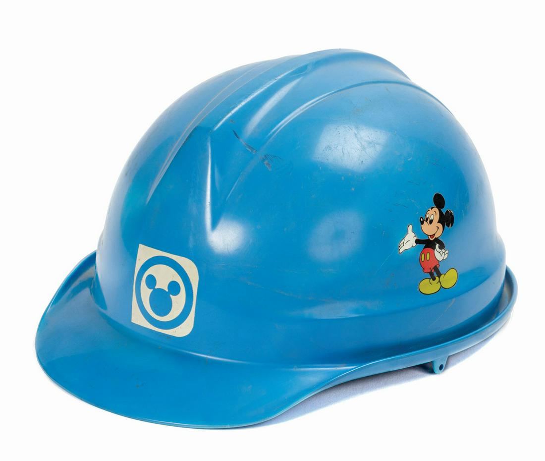 Tokyo Disneyland Project Coordinator Hard Hat.: (Tokyo Disneyland, c.1979) A hard hat used by a project coordinator for Tokyo Disneyland. The hard hat features Mickey on one side, and the Tokyo Disneyland logo on the front and opposing side. The op