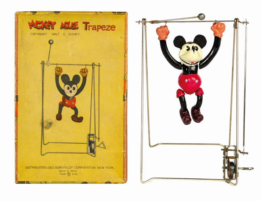 Mickey Mouse Trapeze Wind-Up Toy.: (Borgfeldt, c.1930s) A vintage Mickey Mouse Trapeze wind-up toy manufactured in Japan and distributed by Borgfeldt. When the integral key on the device is wound, the crossbar holding Mickey is turned,