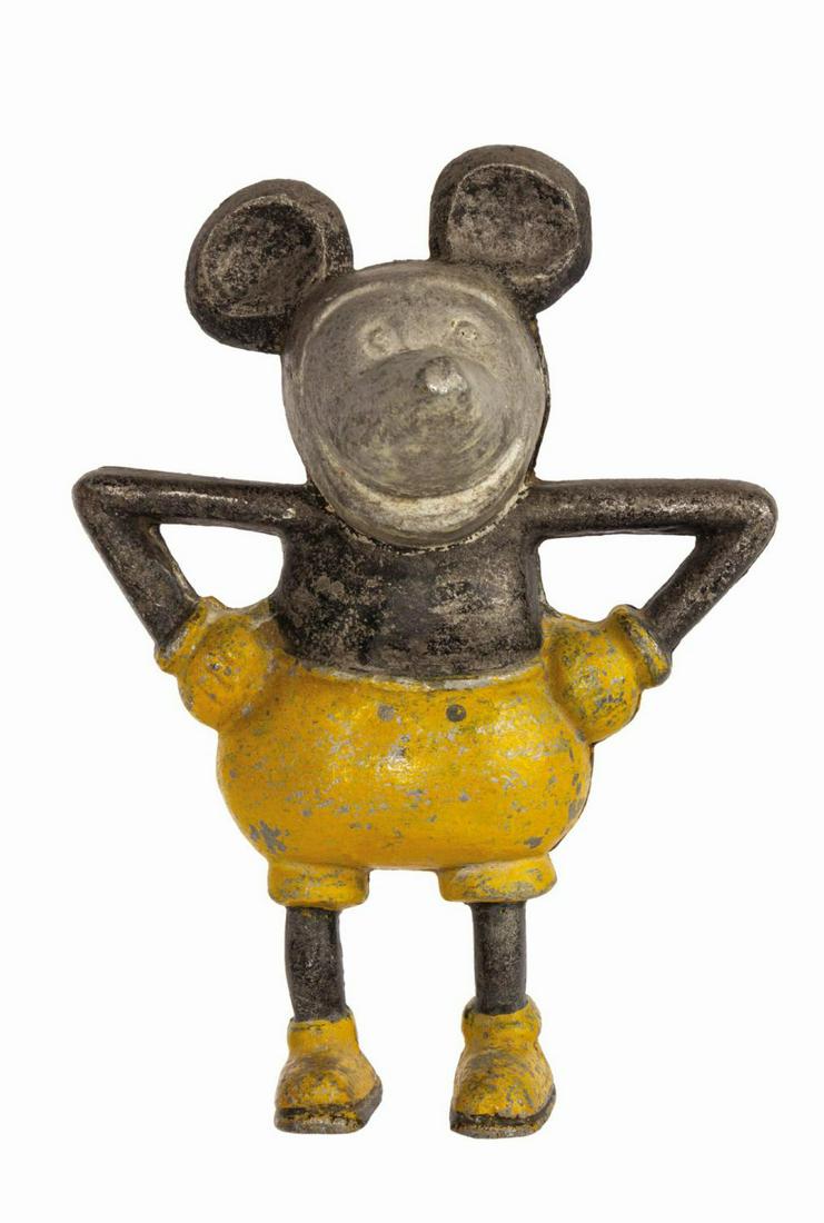 Mickey Mouse Cast Iron Coin Bank.: (Disney, c.1930s) A vintage Mickey Mouse cast iron coin bank. The bank consists of two pieces joined with a washer, nut, and screw in Mickey's back. Measuring 8"x6" and 3.25" deep, the figure is in go