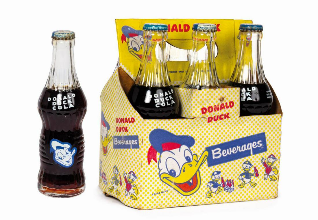 Donald Duck Cola Six Pack.: (Commercial Beverage Co., c.1940s) A vintage six pack of Donald Duck Cola, including (6) sealed bottles of soda and a paper six pack holder. This signature soda was manufactured from 1940 until 1950. 