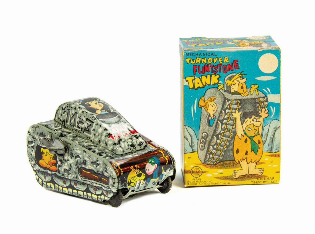 Mechanical Turnover Flintstone Tank Toy in Box.: (Linemar, 1961) A wonderful tin toy based on Hanna-Barbera's The Flintstones. Created by Linemar, a subsidiary of Marx Toys, the wind-up tin litho toy features several of the cartoon's characters on t