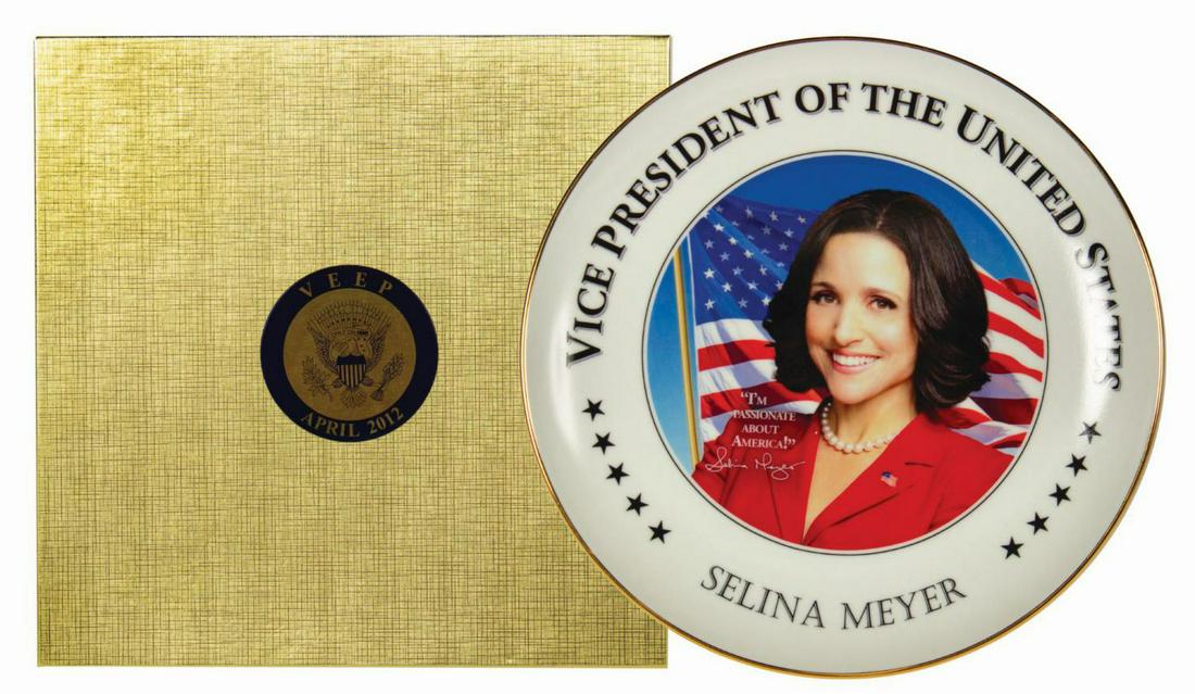 VEEP Promotional Launch Commemorative Plate.: (HBO, 2012) A commemorative plate created for the promotional launch of the television show VEEP. The plate features an image of Julia Louis-Dreyfus in her role as Selina Meyer along with the text: "V