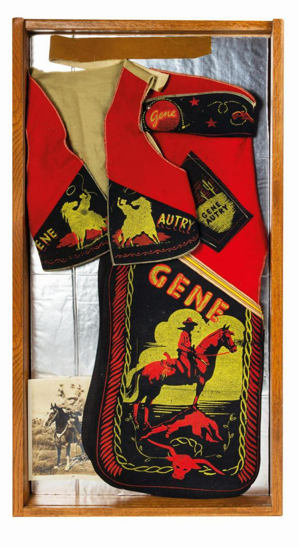 Gene Autry Children's Costume Framed Display.: (c.1940s-50s) A vintage Gene Autry (3) piece children's Western costume. The set consists of a vest, chaps, and a belt. The vest is constructed of red and black felt with a pale denim backing. Elabora