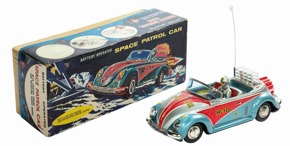Space Patrol Car Tin Toy.: (Nomura, c.1960s) An exceedingly rare vintage tin lithographic Space Patrol electronic car. Based on a convertible Volkswagen Beatle, a slider switch on the bottom of the vehicle turns on the lights, 