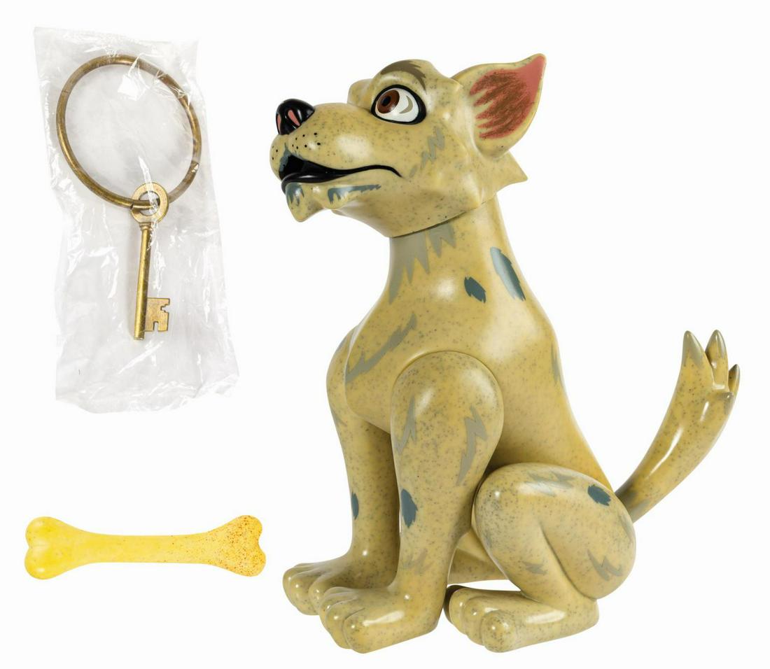 Pirates of the Caribbean Key Dog Figure.: (Disneyland, 2009) A Pirates of the Caribbean Key Dog vinyl figure manufactured by Span of Sunset. The dog is accompanied by a key on a ring and a bone-shaped squeaker toy. The original cardboard and