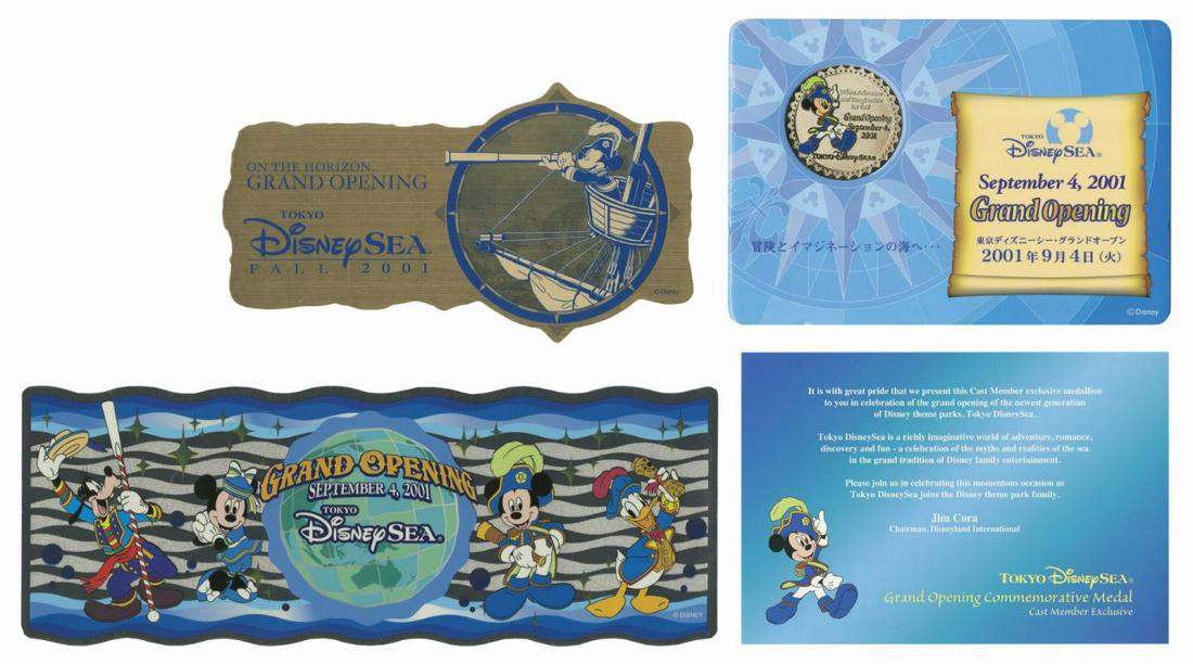 Tokyo DisneySea Grand Opening Coin & Stickers.: (Tokyo DisneySea, 2001) A collection of (3) items celebrating the grand opening of Tokyo DisneySea. Included are (2) unused stickers and a commemorative medallion. The gold-colored pre-opening sticker