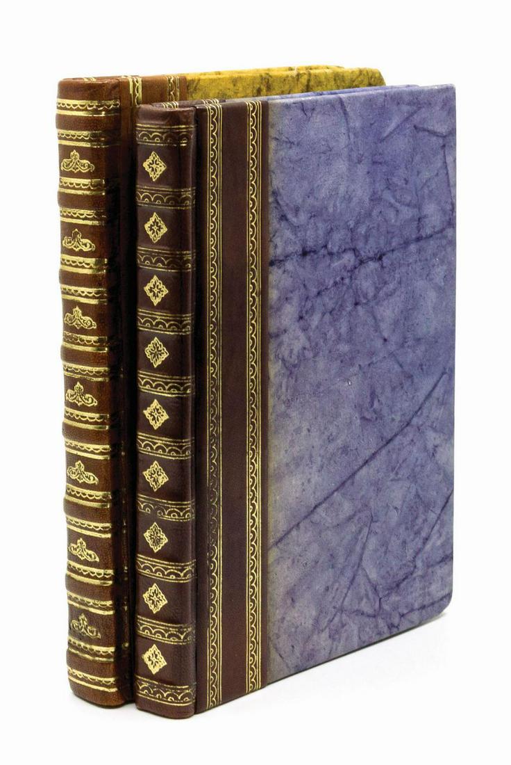 Pair of Prop Books from the Last Crusade.: (Paramount, 1989) A pair of static prop books from Indiana Jones and the Last Crusade, from the collection of a former studio employee. The quarter leather volumes feature stamped embellishments on th