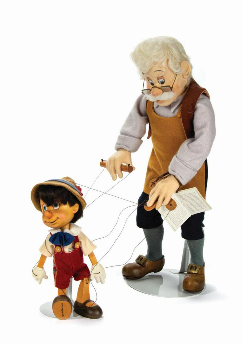 Geppetto & Pinocchio R. John Wright Dolls.: (Disney, 1995) A limited edition "Series I Marionette” doll set created by R. John Wright. Based on original animators' drawings and models from the Disney archives, Geppetto is constructed of f