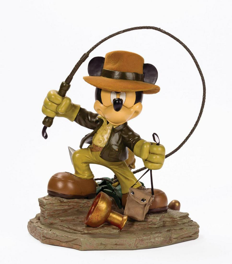 Indiana Mickey Medium Fig and Expedition Poster.: (Disneyland, 2008) A Mickey Mouse as Indiana Jones park exclusive Medium Fig designed by Costa Alavezos for the Art of Disney Theme Parks collection. Constructed of cast resin, the intricately sculpte