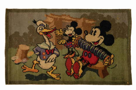 Donald, Minnie, Mickey Dancing Tapestry Rug.: (Disney, c.1930s). A vintage woven tapestry rug depicting Mickey Mouse playing the squeezebox as a long-billed Donald Duck and Minnie Mouse dance in a wooded outdoor setting. Measuring 44"x26", the