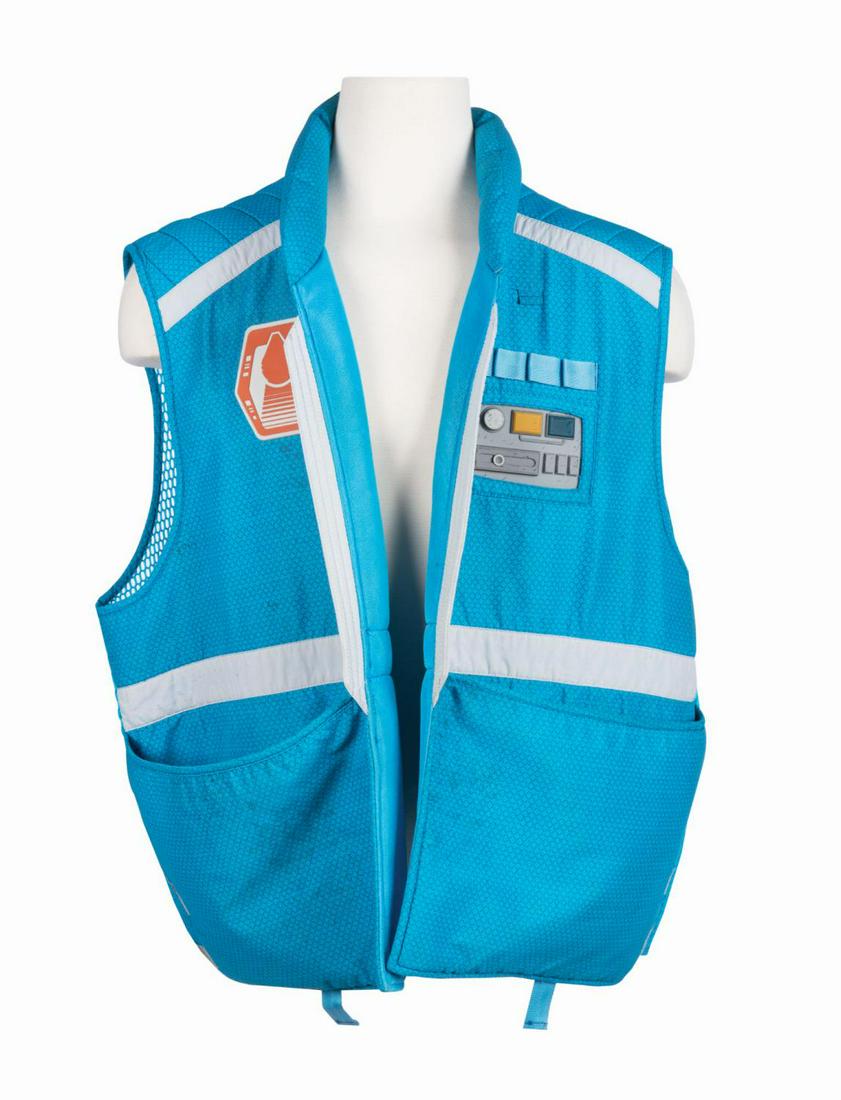 Smugglers Run Cast Member Vest.: (Disneyland, 2019) A cast member uniform vest for the Star Wars: Millennium Falcon - Smugglers Run attraction in Star Wars: Galaxy's Edge. The futuristic vest features a padded standing collar, scallo