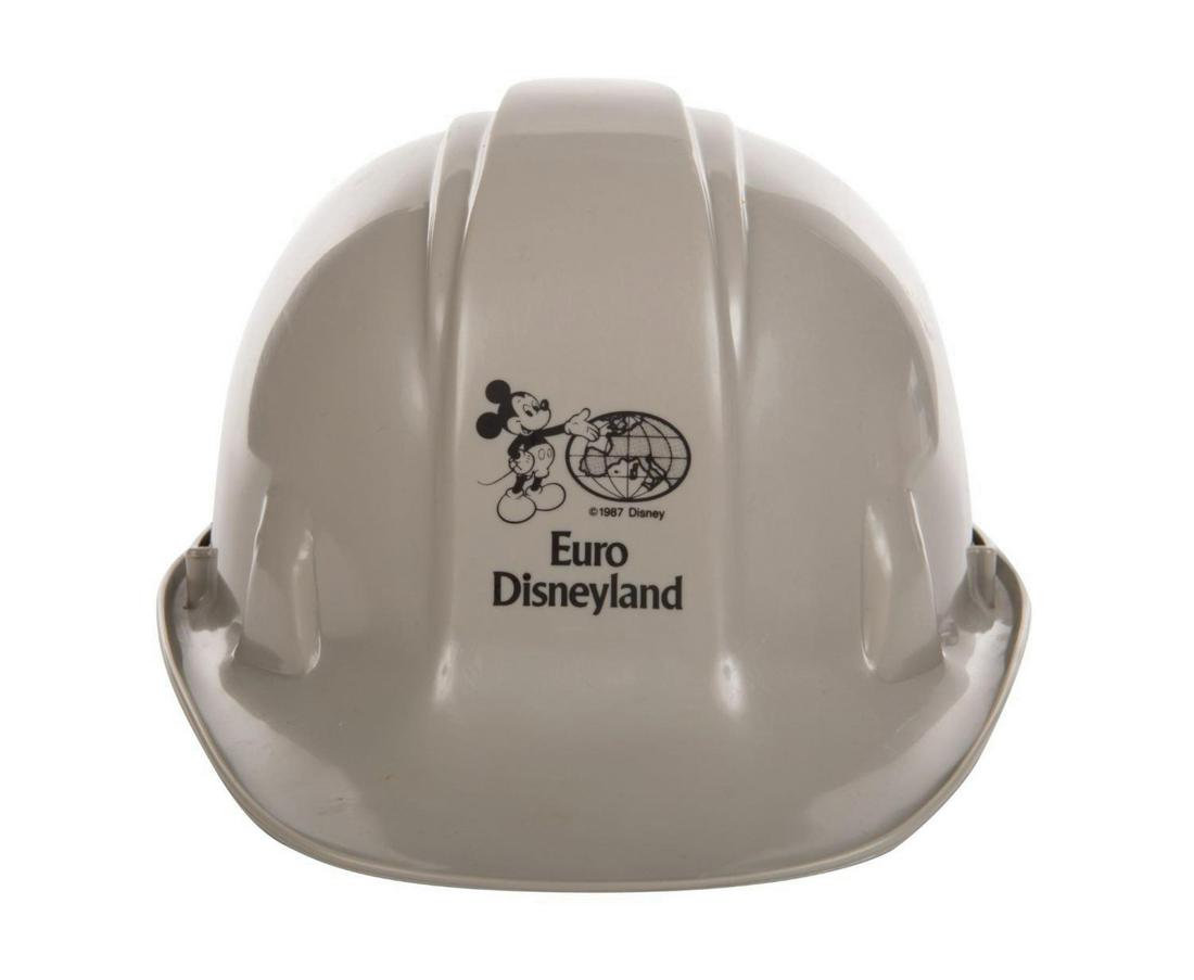 Euro Disneyland Hard Hat.: (Disneyland Paris, 1987) A construction hard hat used during the construction of Euro Disneyland. The grey hard plastic hat features a screen printed logo with Mickey presenting a map of Continental E