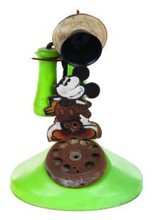 A Mickey Mouse Toy Candlestick Telephone.: (N.N. Hill Brass Co., 1934) A Mickey Mouse Candlestick Phone by N.N. Hill Brass Co. The toy features a rotary dial with functioning ringing bell. Measuring 7.5" tall and 5.25" at its widest diameter,