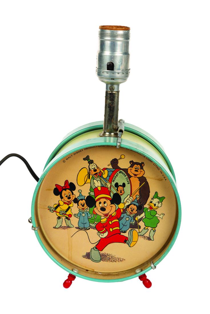Mickey Mouse Club Tin Litho Drum Lamp.: (Econolite, 1950s) A Mickey Mouse Club tin litho bedside lamp from the 1950s. In bass drum shape, both sides feature the image of Mickey and other characters from the Mickey Mouse Club opening titles.