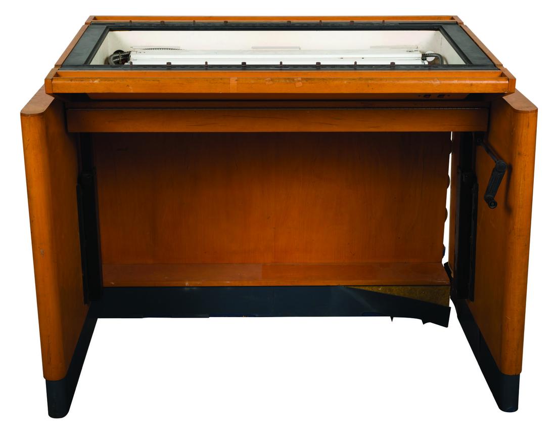 A Disney Studio Kem Weber Inspired Drafting Table: A rare Walt Disney Studio-used "Kem Weber-like" drafting table from the Disney Feature Animation Studio in Orlando. The light surface viewable area measures 19"x42" and is adjustable by height and til