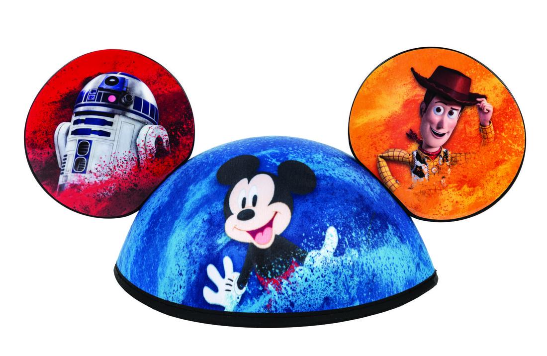 D23 Expo 2019 Exclusive Mouse Ears.: (Disney, 2019) Colorful Mickey Mouse ears exclusive to the D23 Expo in 2019. With a cheerful Mickey Mouse on the cap, the ears are decorated with characters from the Disney Studios top franchises. R2-