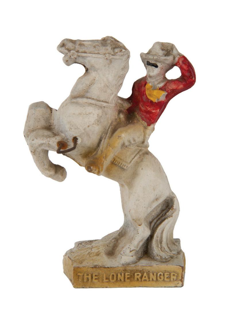 The Lone Ranger and Silver Toothbrush Holder.: (Lone Ranger, 1938) A painted composition figure of the Lone Ranger riding Silver. A wire hook is affixed to Silver's hip to hold a toothbrush. Measuring 4.25"x3", the figure is in good condition, wit