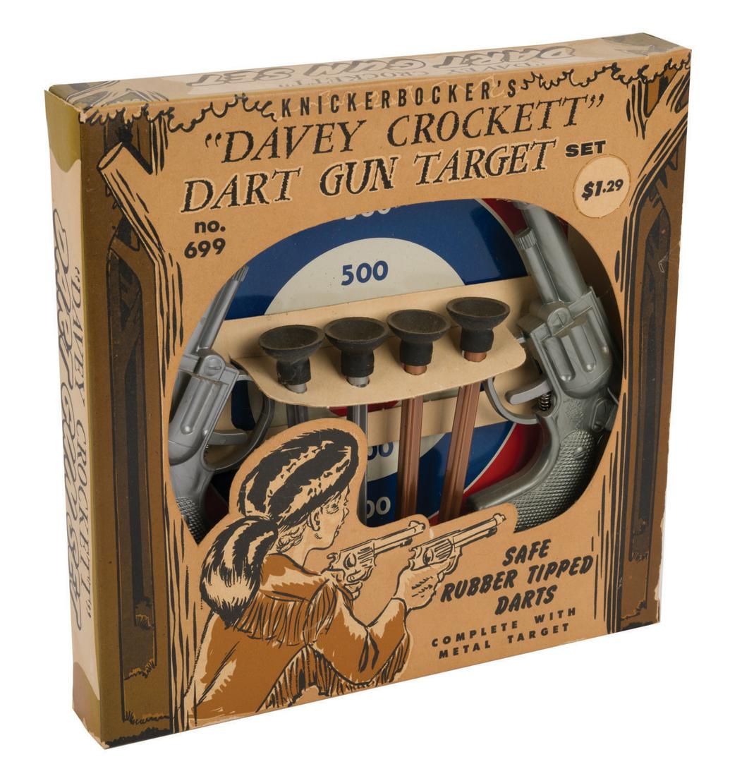 A "Davey" Crockett Dart Gun Target Set.: (Knickerbocker, 1950's) A Davey Crockett Dart Gun Set by Knickerbocker in the original box. The set includes (2) dart guns, (4) rubber tipped safety darts, and (1) metal target. The set is in fine unu