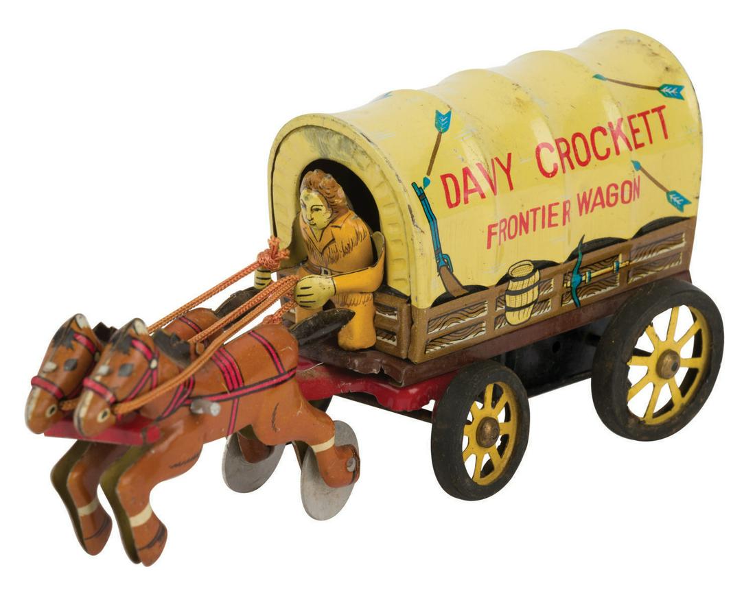 A Davy Crockett Friction Frontier Wagon by LineMar.: (LineMar, 1950s) A Davy Crockett Friction Frontier Wagon manufactured in Japan by LineMar Toys. The tin Wagon toy features vibrant lithographic imagery with bright cloth cord reigns and was part of th