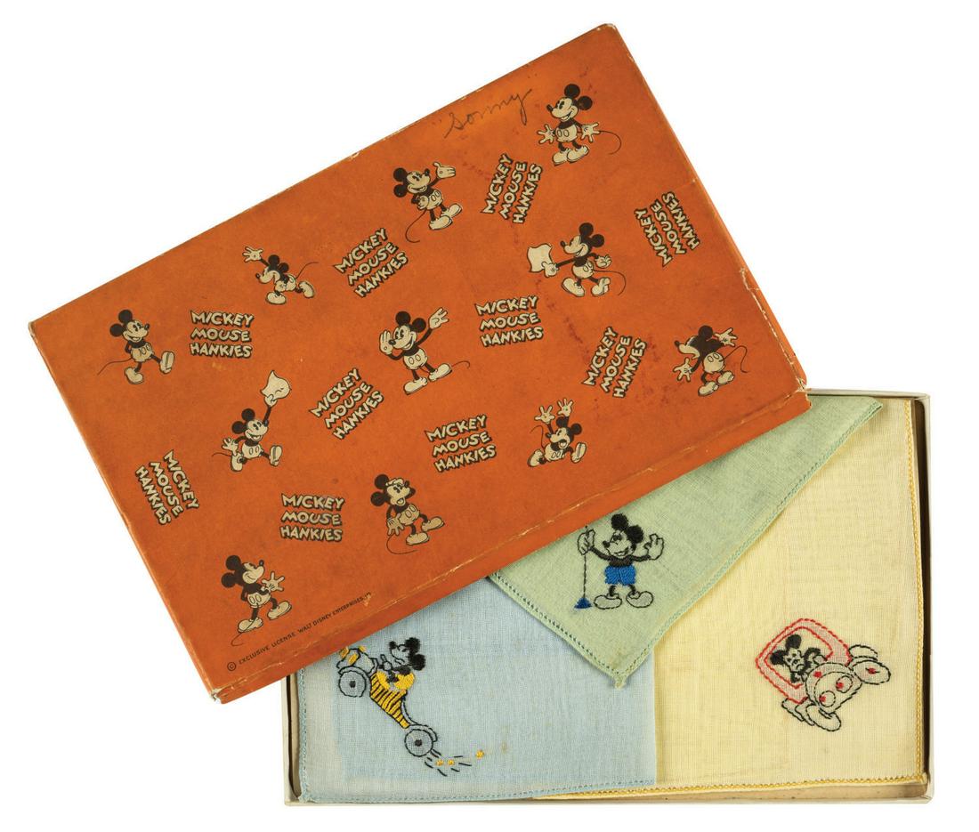 A Boxed Set of 1930 Mickey Mouse Handkerchiefs.: (Hermann Handkerchief Co., 1930) A set of (3) Handkerchiefs embroidered with images of Mickey driving cars and holding a stop sign. The handkerchiefs are some of the first produced in 1930 by early li