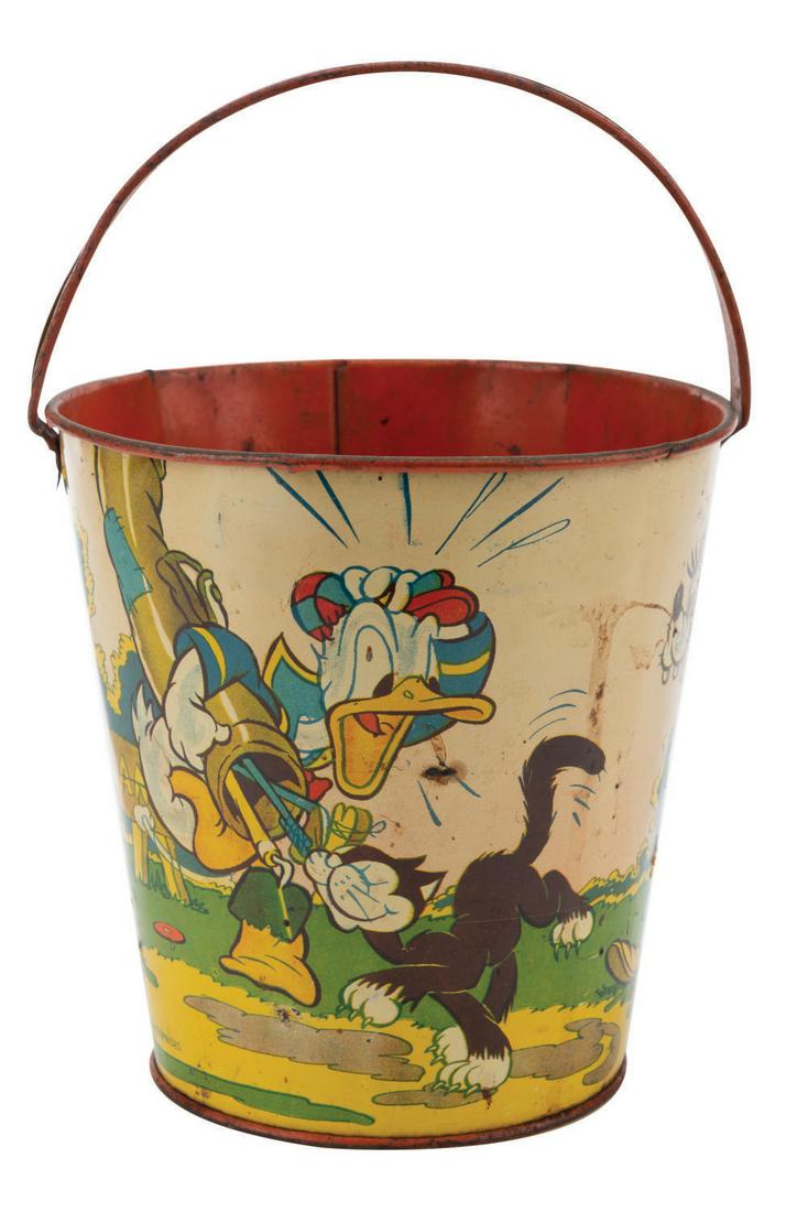 A Mickey, Goofy & Donald Golfing Sand Pail by Ohio Art.: (Ohio Art, 1938) A large-sized tin lithographic sand pail by Ohio Art Company featuring Mickey Mouse, Goofy, and Donald Duck golfing. Measuring 6"x 6" tall, the metallic bucket displays in good condit