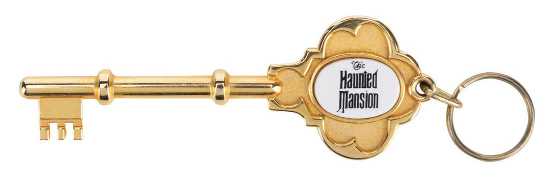 A Haunted Mansion Souvenir Key Chain.: (Disneyland, 2000s) A key-shaped souvenir of the Haunted Mansion at Disneyland. Metallic souvenir key fobs of this style featuring a cameo with the attraction name were manufactured for several advent
