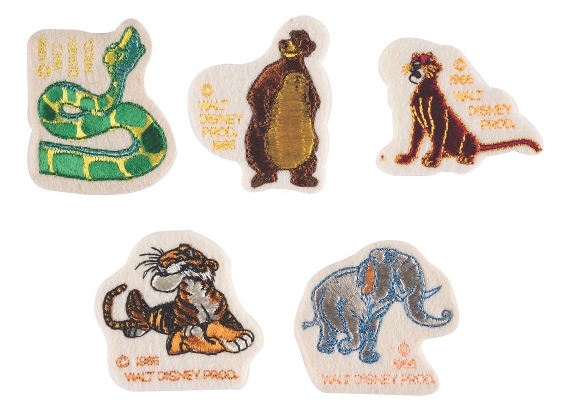 A Set of Jungle Book Embroidered Patches.: (Disney, 1966) A Set of five embroidered iron-on patches of characters from The Jungle Book. Included are Kaa, Colonel Hathi, Bagheera, Baloo, and Shere Khan, with instructions in their original 4"x6.
