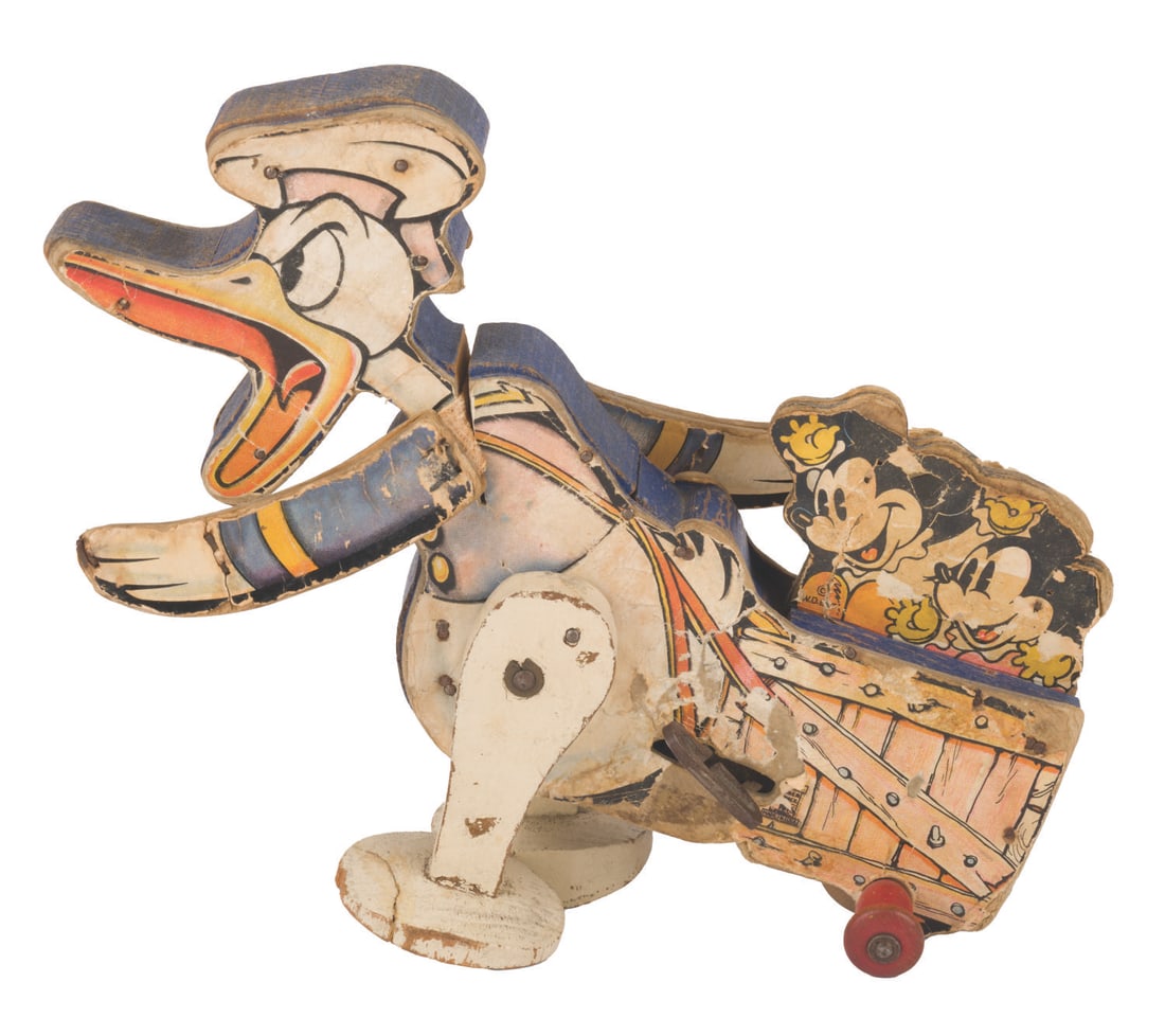 A Fisher-Price Donald Duck "Walky Balky" Back-Up Toy.: (Fisher-Price, 1936) A Fisher-Price Donald Duck "Walky Balky" Back-Up toy #358, featuring Donald and Mickey's Orphans, designed with a flapping arm motion triggered when the key is wound. The keyed me