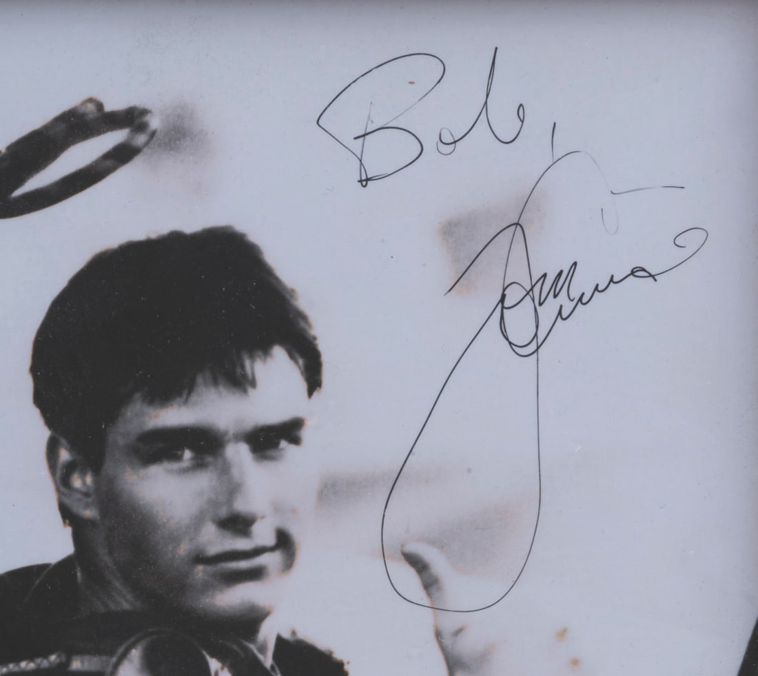 A Tom Cruise Signed "Top Gun" Photo.: (Paramount, 1986) A signed photo of Tom Cruise in “Top Gun.” The black and white glossy photo features the actor’s signature in the top right corner and is addressed to “Bob.” Measur