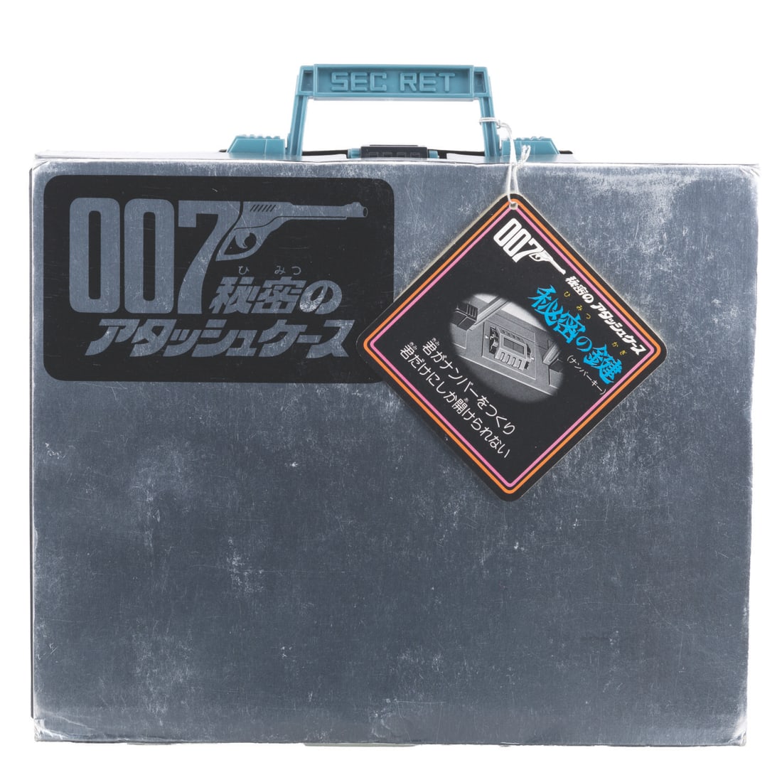 A Nomura James Bond Moonraker Attache Case.: (Nomura, 1979) A James Bond 007 Moonraker attache case toy. The plastic toy comes complete with a Tiger TMG 747 plastic toy gun, six red plastic bullets, a walkie-talkie, a decoder with inserts, a roc