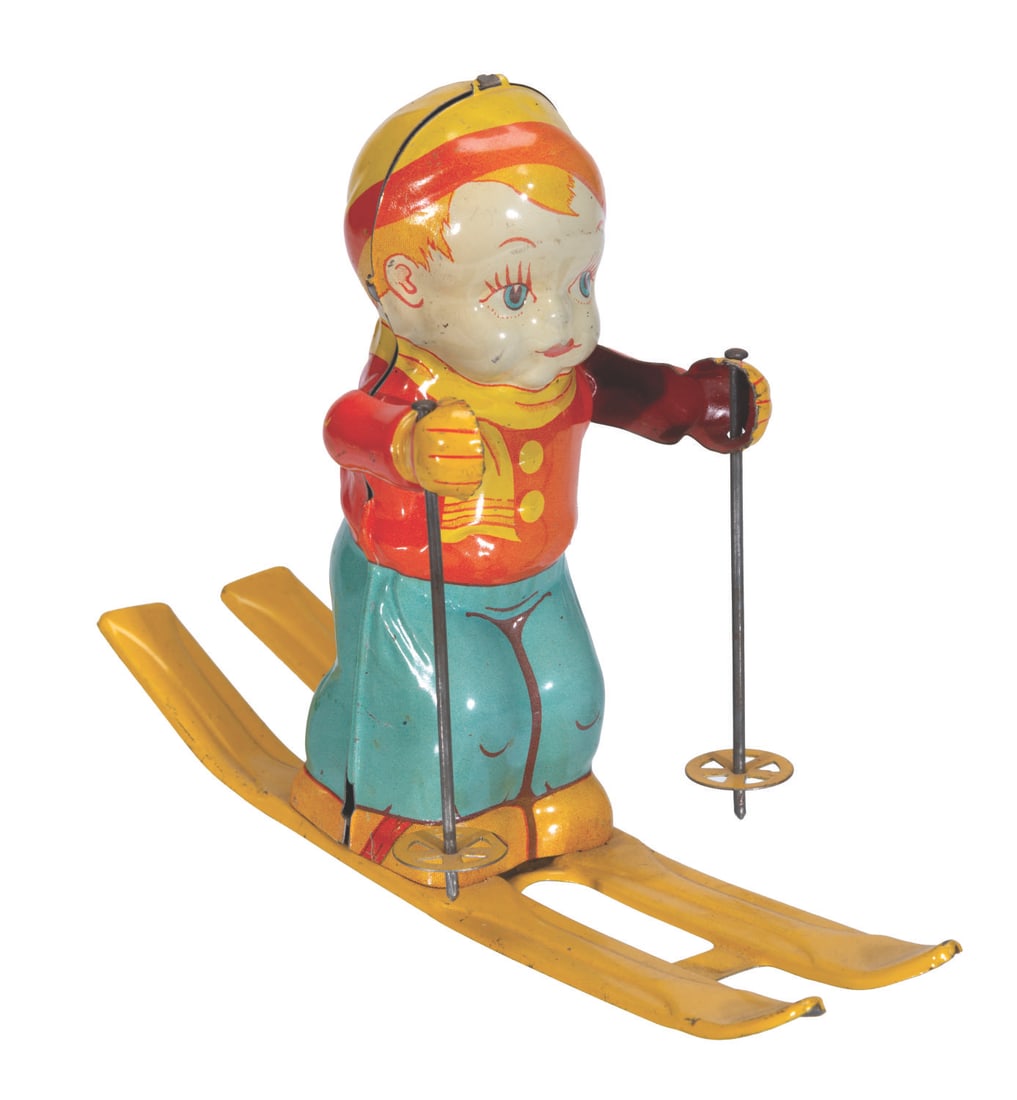 A Skiing Child Wind-Up Tin Toy.: (Chein, 1950s) A skiing child wind-up tin litho toy manufactured by Chein. When wound, the child raises its ski poles up and down and moves forward. Measuring 3.25” x 7.5” x 5.75” ta