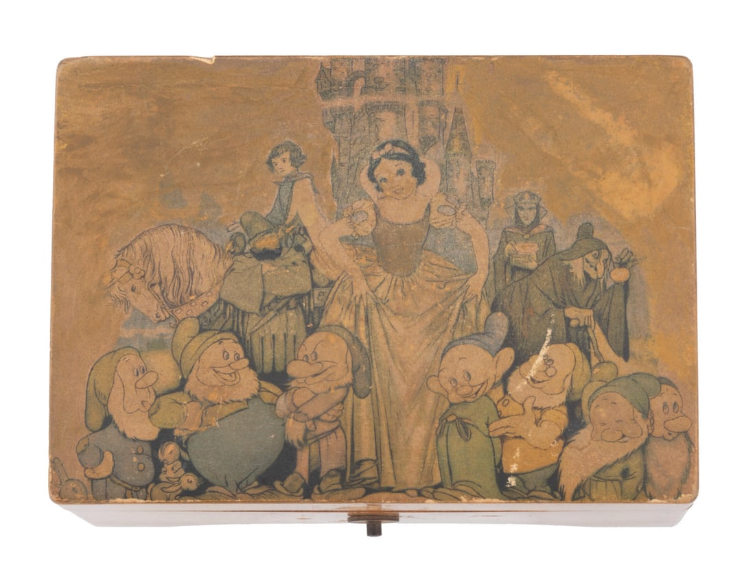 A "Snow White and the Seven Dwarfs" Music Box.: (Julius Garfinckel & Co., 1930-1950s) A "Snow White and the Seven Dwarfs" music box made in Switzerland that plays "Whistle While You Work," and "Heigh Ho." Measuring 5" x 3.5" x 2.5", the wooden and