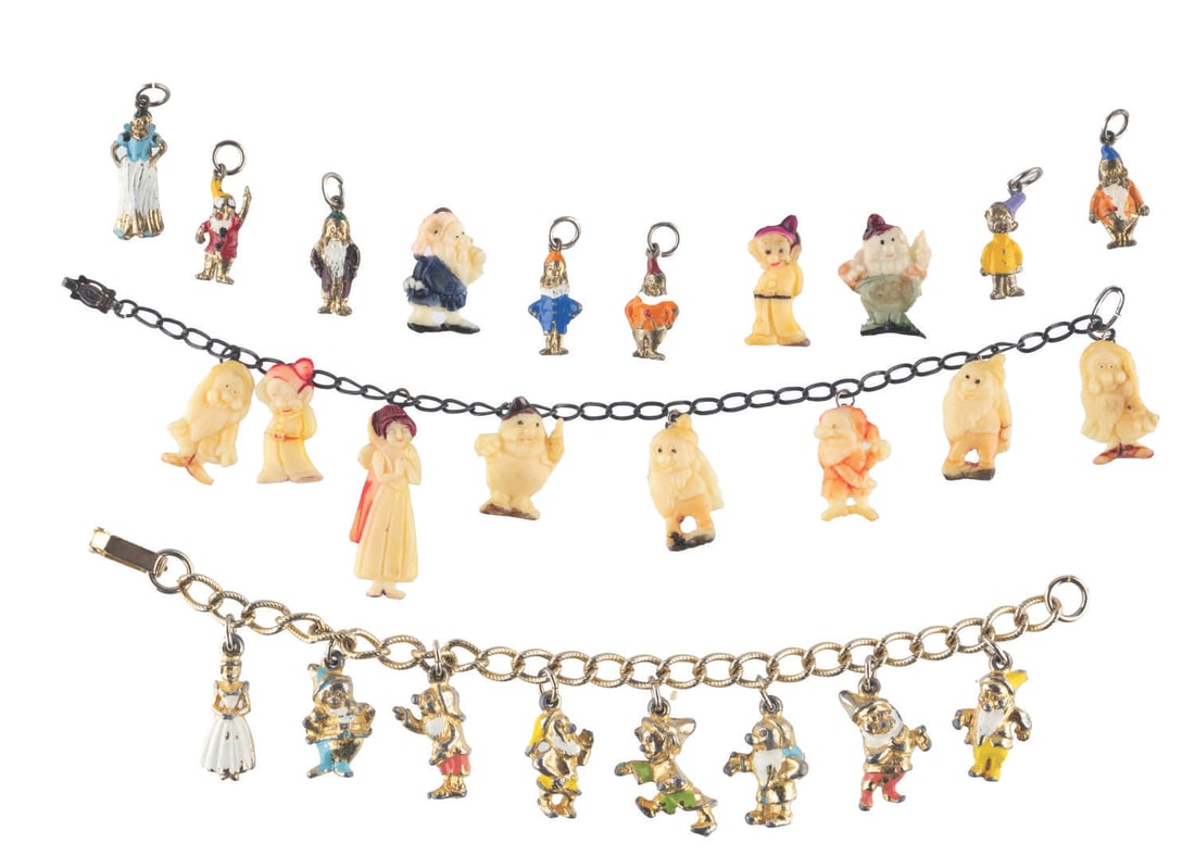 "Snow White and the Seven Dwarfs" Braclets and Charms.: (Disney, 1940s-60s) A collection of two "Snow White and the Seven Dwarfs" metal charm bracelets, each with eight charms (one set made of celluloid, and one of metal) and ten separate charms without a