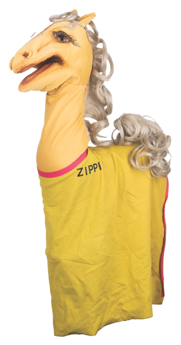 A “Thunderbolt the Wondercolt?? Zippi Horse Puppet.: (Clampett, 1952) A glamorous “Thunderbolt the Wondercolt” Zippi horse puppet wearing purple bejeweled glasses and a yellow racing outfit that covers its felt body. Measuring 18” x 5.5&rd