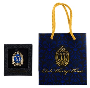 A Club 33 Updated Logo Pin and Bag.