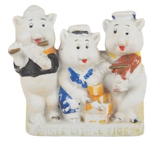 A 1930s Three Little Pigs Bisque Toothbrush Holder.