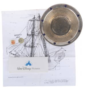 A Collection of “Muppet Treasure Island" Props and Ephemera.: (Disney, 1996) A collection of production materials and props from “Muppet Treasure Island.&rdquo; Included are a reference photocopy blueprint for the Hispaniola, two prop gold-toned plastic doublo