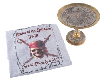 A "Pirates of the Caribbean" Crew Shirt and Mermaid Dish Prop.