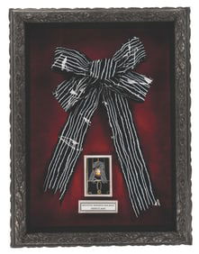 A Haunted Mansion Holiday Overlay Bow Prop.