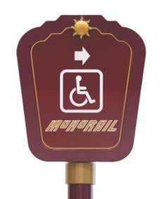A Monorail Stanchion with Wheelchair Accessibility Sign.
