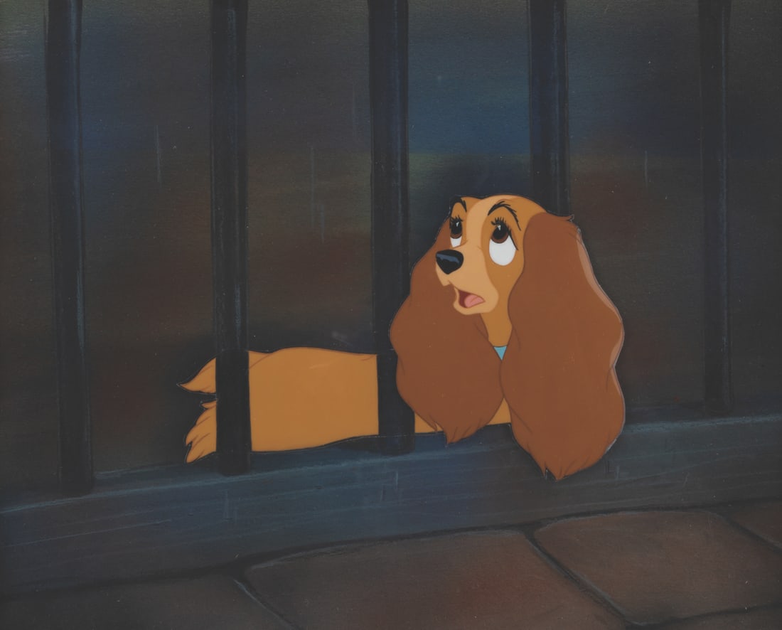 A "Lady and the Tramp" Original Production Cel.: (Disney, 1955) An original production cel of Lady from "Lady and the Tramp" with a custom hand-painted presentation background. The cel has been trimmed to image measuring 3.5" x 9" on the 7.5" x 9" b