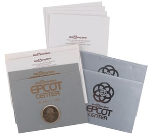 A Collection of EPCOT Opening Day Medallions and Event Invitations.