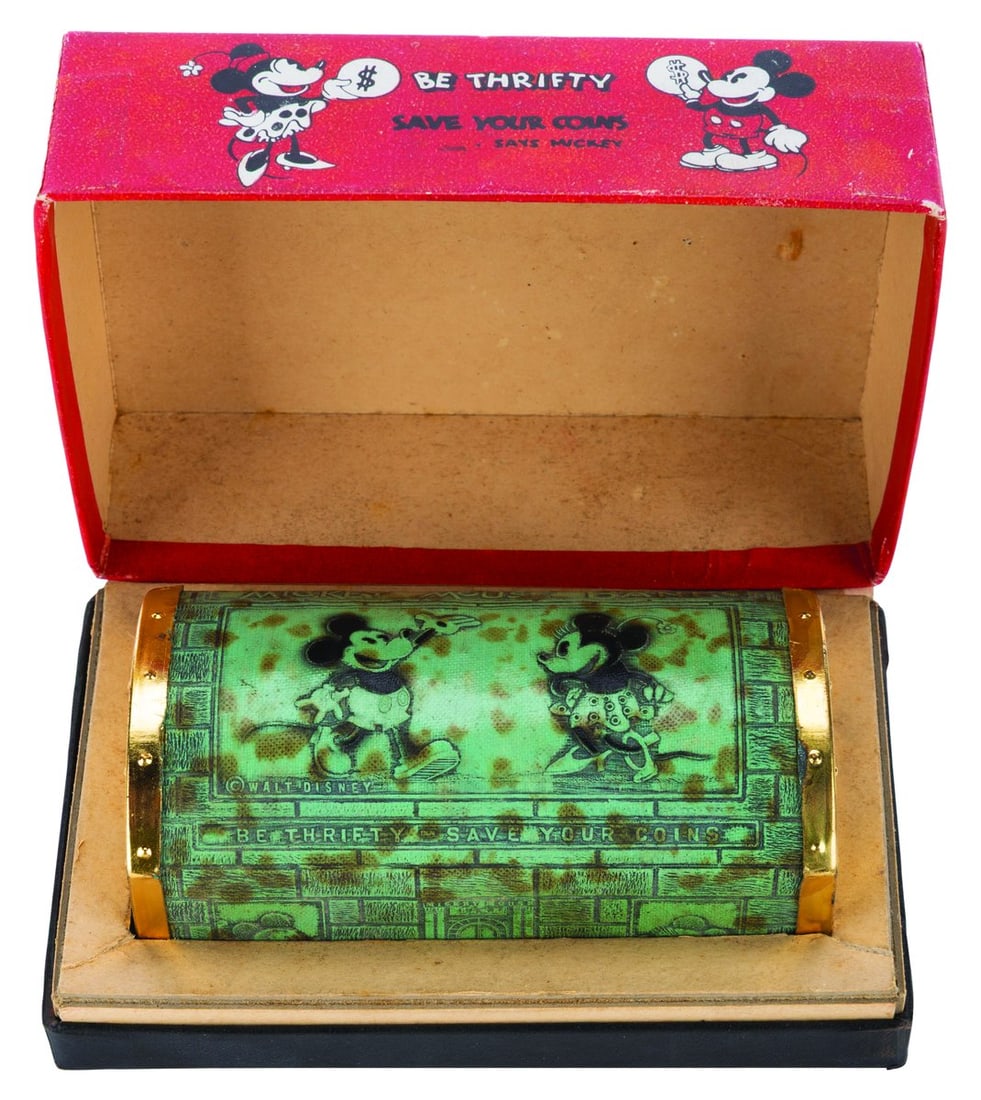 A Mickey Mouse Zell Chest Bank with Box.: (Zell, 1930s) An early Mickey Mouse chest bank, complete with its very rare hinged original box featuring Mickey, Minnie, and Pluto. Measuring 2" x 4.25" x 2" tall with its 5.25" x 3.5" x 2.25" tall b