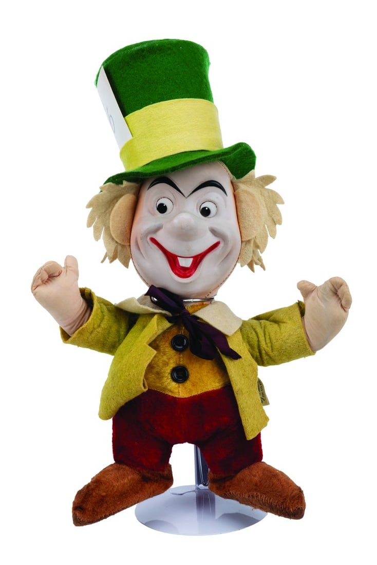 A Rare Gund Mad Hatter Doll.: (Gund, 1951) A rare plush doll of the Mad Hatter from "Alice in Wonderland," manufactured by Gund. The doll has an internal wire armature and features a molded plastic face, felt hair, and a felt coat