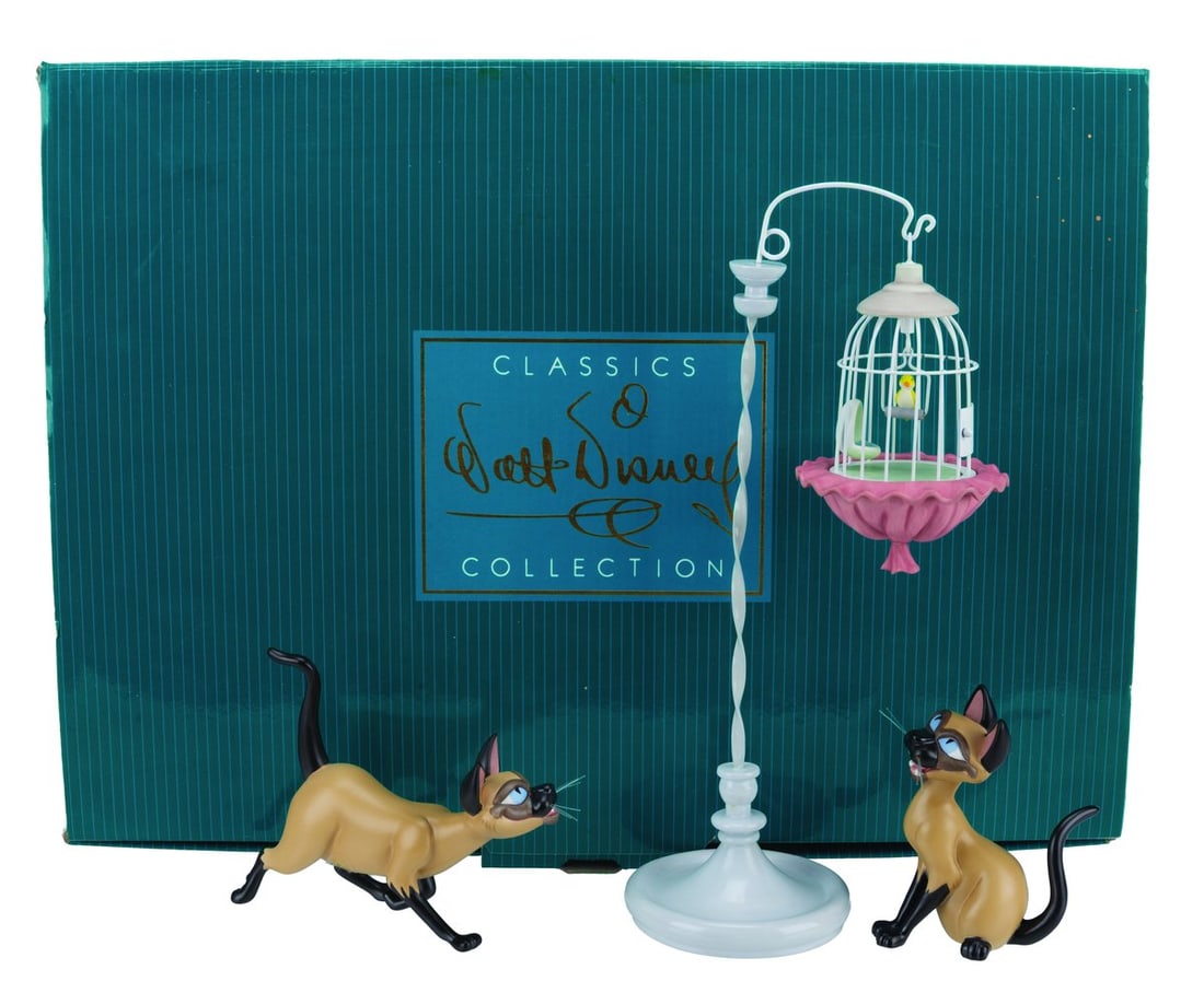 A WDCC “Lady and the Tramp?? Si & Am Figurine Set.: (WDCC, 2002) A figurine set titled "We are Siamese if You Don't Please" featuring Si and Am from "Lady and the Tramp," part of the Walt Disney Classics Collection's Disney Duos series. Ranging in size