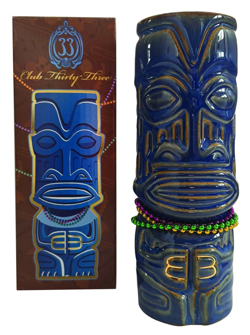 A SHAG Club 33 Mardi Gras Blue Mug.: (Disneyland, 2022) A Club 33 Mardi Gras tiki mug designed by SHAG, complete with its original beads. Released in a limited edition of 2500, the mug is signed on the bottom and box by SHAG and features