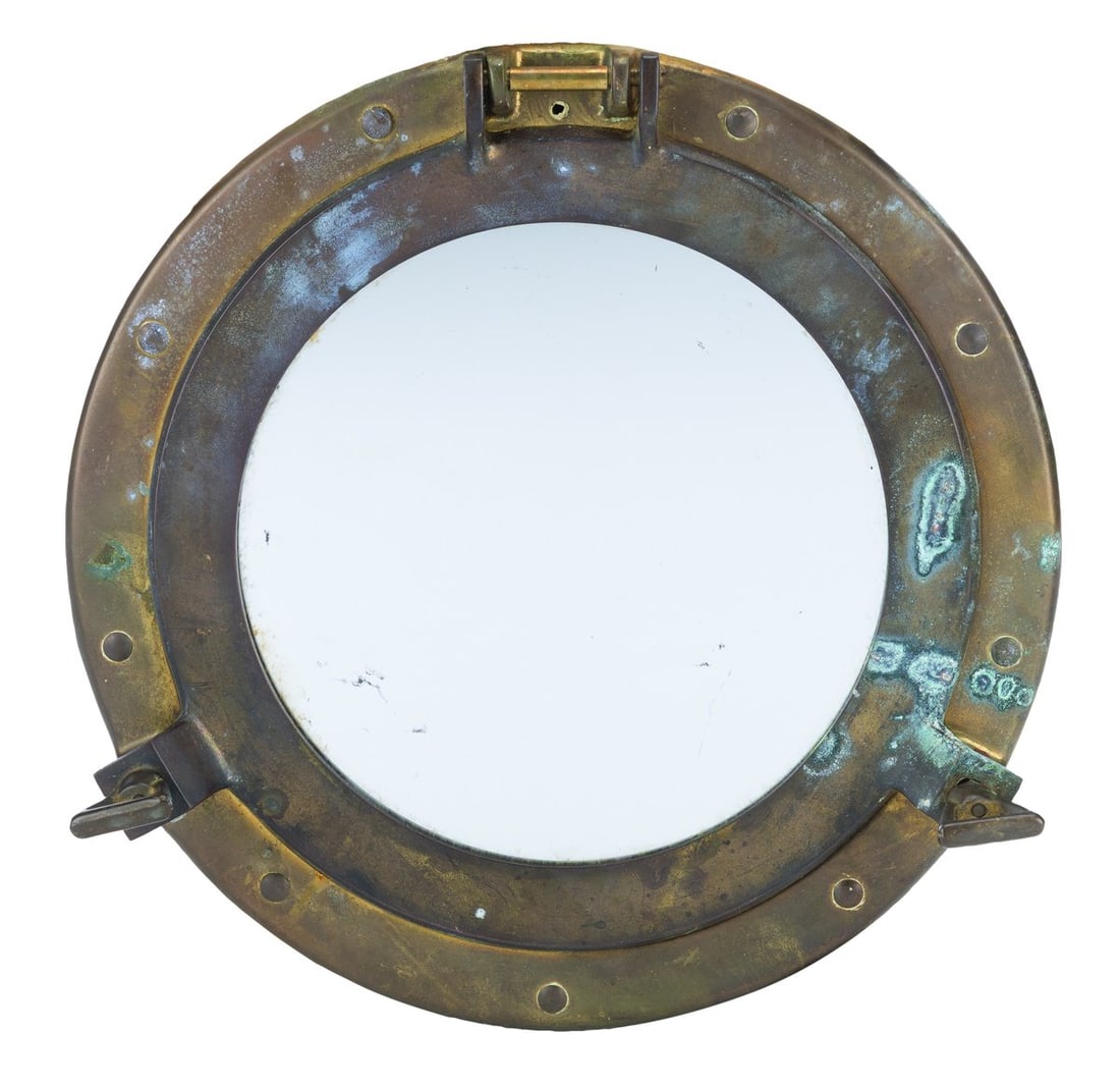 A Swiss Family Treehouse Mirror Prop.: (Disneyland, 1962-99) An original nautical-themed porthole mirror prop from the Swiss Family Treehouse attraction in Adventureland. Measuring 11" in diameter, the mirror is in fair condition with heav